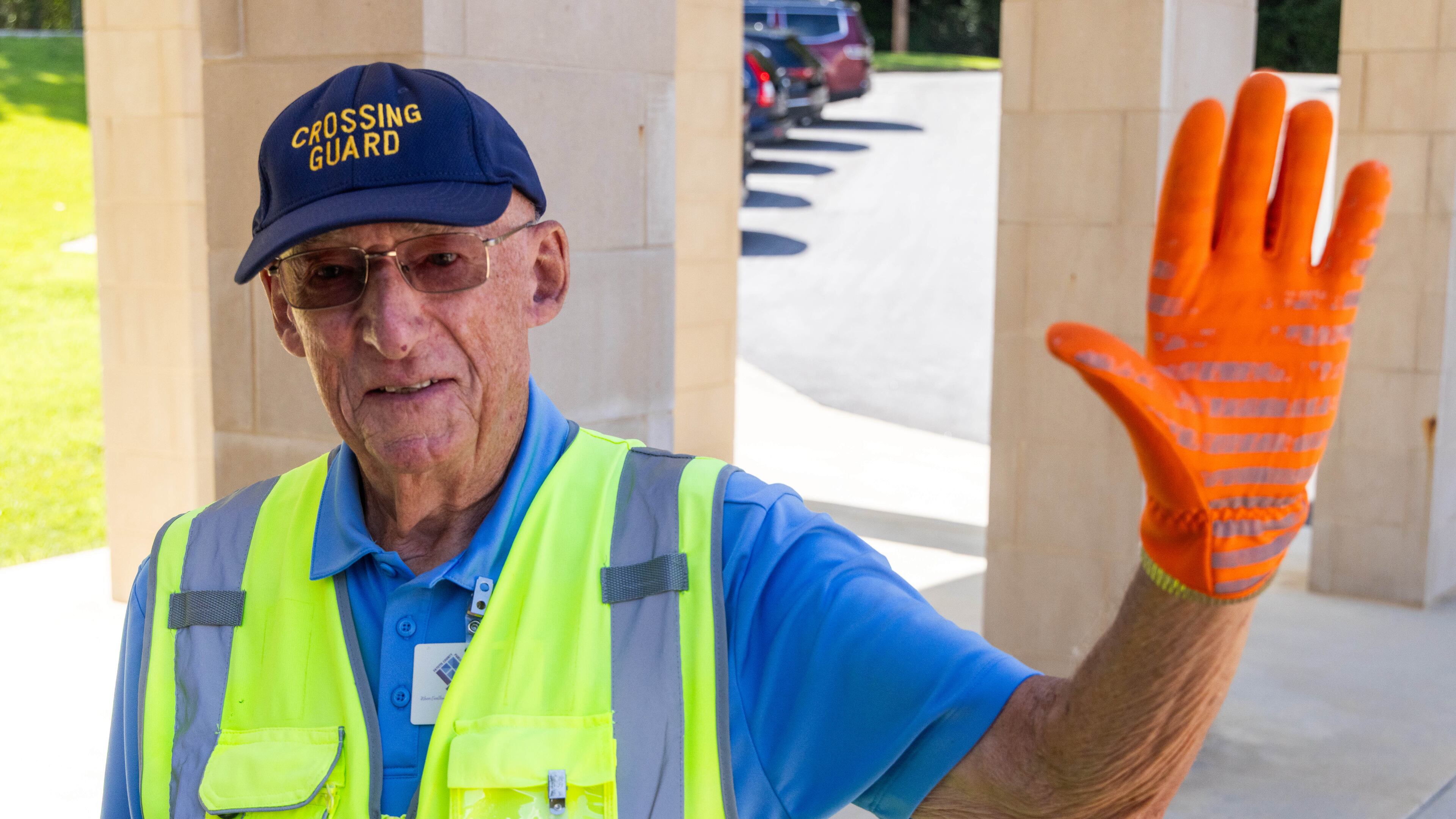 Although the cold and rainy days aren't fun, “working at a grade school, you see the little guys, and it makes it all worthwhile,” said Ted Masters, the oldest school crossing guard in Peachtree City. (Phil Skinner for the AJC)
