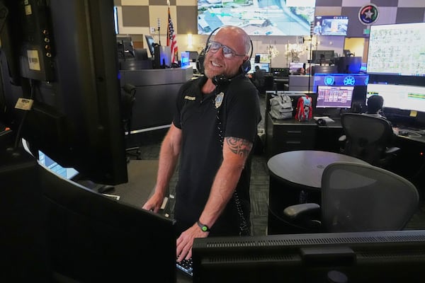 Senior dispatcher Jude Sannicandreo responds to an emergency call at the Collier County Emergency Services Center, Friday, July 11, 2025, in Naples, Fla. (AP Photo/Marta Lavandier)