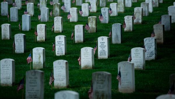 Flags are seen at graves in Arlington National Cemetery during "Flags In" in preparation for Memorial Day May 25, 2017 in Arlington, Virginia. / AFP PHOTO / Brendan Smialowski        (Photo credit should read BRENDAN SMIALOWSKI/AFP/Getty Images)