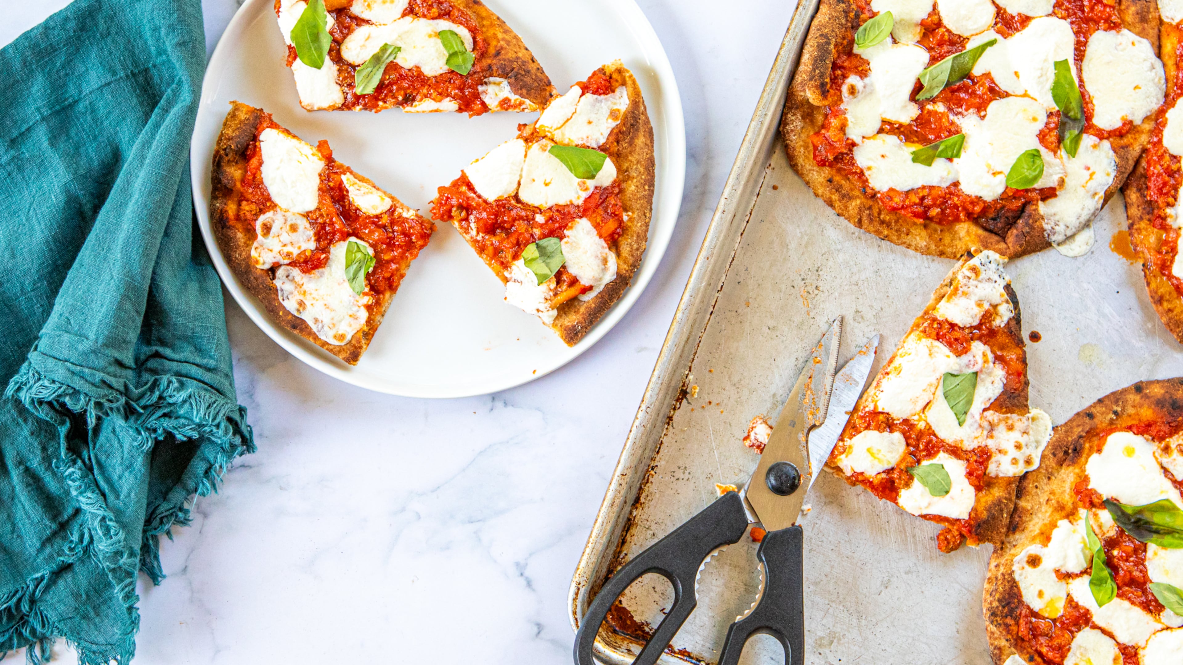 Naan provides a simple stand-in for the crust in homemade versions of the Bolognese pizza from Lloyd's Restaurant and Lounge in Inman Park. (Credit: Aaliyah Mann for the AJC, styling by Kate Itrich-Williams)