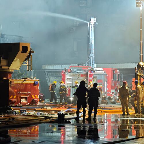 In this photo released by Xinhua News Agency, firefighters work at the scene of a footwear factory fire in Jiangtou village, Chendai township of Jinjiang city, southeastern China's Fujian province, on Thursday, July 9, 2026. (Zhou Yi/Xinhua News Agency via AP)