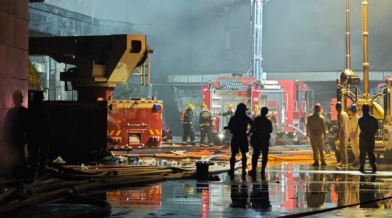 In this photo released by Xinhua News Agency, firefighters work at the scene of a footwear factory fire in Jiangtou village, Chendai township of Jinjiang city, southeastern China's Fujian province, on Thursday, July 9, 2026. (Zhou Yi/Xinhua News Agency via AP)