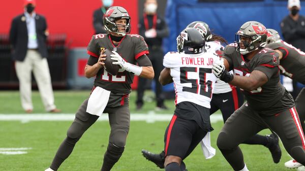 Tampa Bay Buccaneers quarterback Tom Brady (12) looks to pass against the rush of Atlanta Falcons defensive end Danter Fowler during the first half Sunday, Jan. 3, 2021, in Tampa, Fla. (Mark LoMoglio/AP)