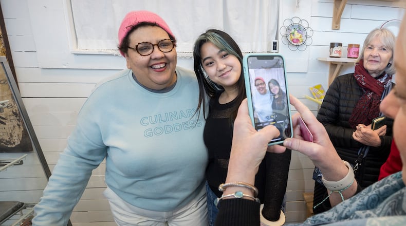 Back in the Day Bakery owner Cheryl Day, left, poses for a photo with customers during the bakery's closing day, Wednesday, Feb. 14, 2024. Day opened the shop in Savannah's Starland District in 2002 and gained passionate followers for her classic sweets. (AJC Photo/Stephen B. Morton)