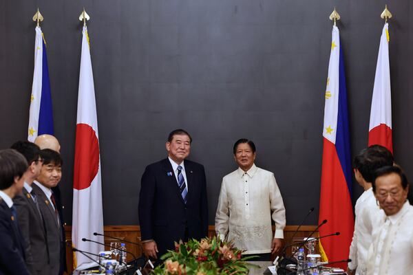 Japan's Prime Minister Shigeru Ishiba, center left, and Philippines President Ferdinand Marcos Jr. pose for a photo before the start of a bilateral meeting at Malacanang Palace in Manila, Philippines Tuesday, April 29, 2025. (Rolex Dela Pena/Pool Photo via AP)