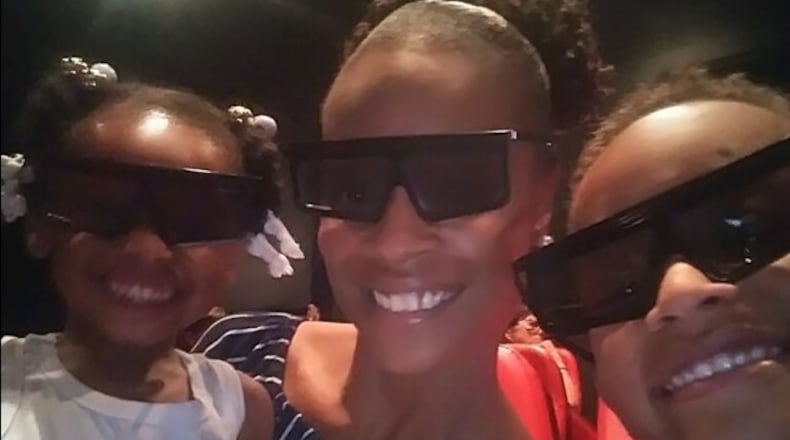 Laquilla Vaughn, pictured with her two children, is suing her apartment complex, alleging it didn't provide adequate security that would've prevented a shooting that injured her.