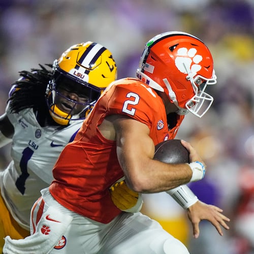 Clemson quarterback Tait Reynolds (2) is sacked by LSU defensive end Princewill Umanmielen (1) in the first half of an NCAA college football game, Saturday, Sept. 5, 2026 in Baton Rouge, La. (AP Photo/Gerald Herbert)
