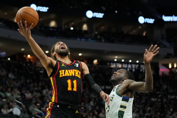 Atlanta Hawks' Trae Young (11) shoots against Milwaukee Bucks' Taurean Prince, right, during the first half of an NBA basketball game Sunday, March 30, 2025, in Milwaukee. (AP Photo/Aaron Gash)