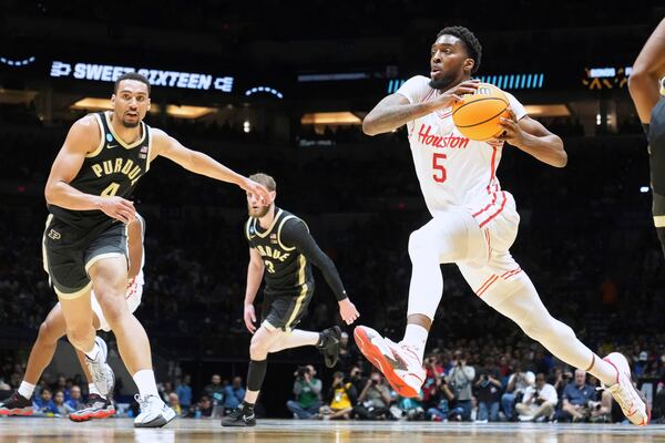 Houston's Ja'Vier Francis (5) drives to the basket past Purdue's Trey Kaufman-Renn (4) during the first half in the Sweet 16 of the NCAA college basketball tournament Friday, March 28, 2025, in Indianapolis. (AP Photo/Michael Conroy)