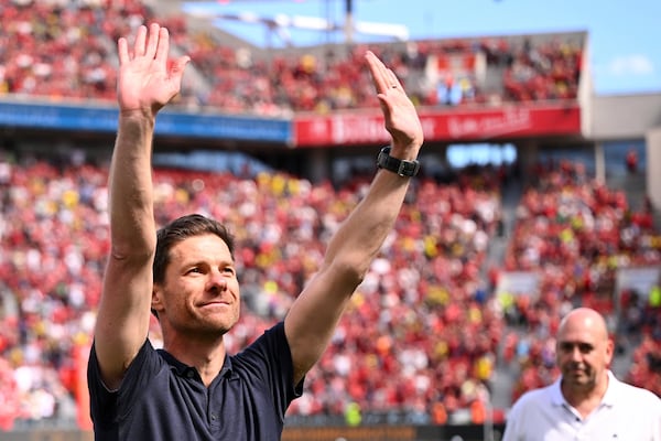 Leverkusen's head coach Xabi Alonso waves to the fans before the German Bundesliga soccer match between Bayer 04 Leverkusen and Borussia Dortmund in Leverkusen, Germany, Sunday, May 11, 2025. (Marius Becker/dpa via AP)