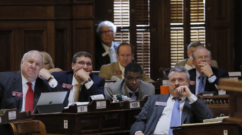 State lawmakers, including Rep. Earl Ehrhart, R-Powder Springs, front right, watch the vote on Feb. 22, 2017, on Ehrhart's bill to ban state funding from colleges that declare themselves "sanctuary campuses." BOB ANDRES / BANDRES@AJC.COM