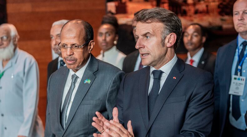 African Union Commission Chairperson Mahmoud Ali Youssouf and France's President Emmanuel Macron, right, interact at the African Union headquarters in Addis Ababa, Ethiopia, Wednesday, May 13, 2026. (AP Photo/Amanuel Sileshi)
