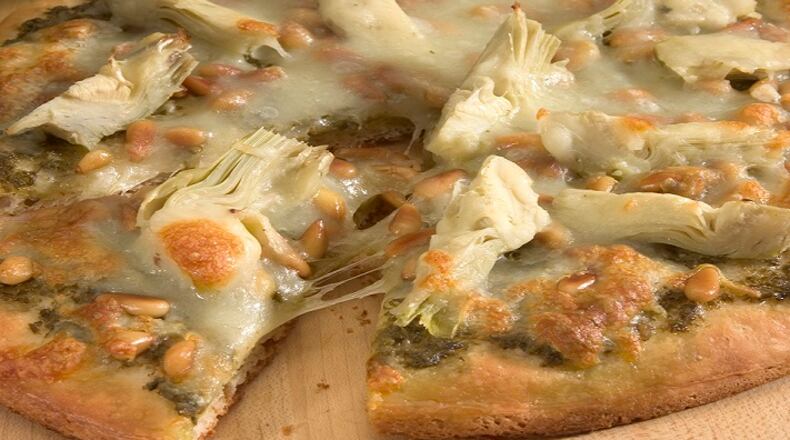 A pesto and artichoke pizza offers a number of wine options, from a rich Italian trebbiano to French chenin blanc to a California grenache and syrah blend. (Chicago Tribune/TNS)