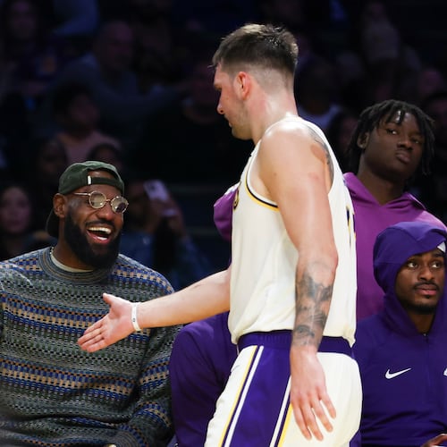 Los Angeles Lakers forward LeBron James, left, and guard Luka Doncic, center, celebrate as forward Jarred Vanderbilt, right, looks on during the second half of an NBA basketball game against the Miami Heat, Sunday, Nov. 2, 2025, in Los Angeles. (AP Photo/Jessie Alcheh)