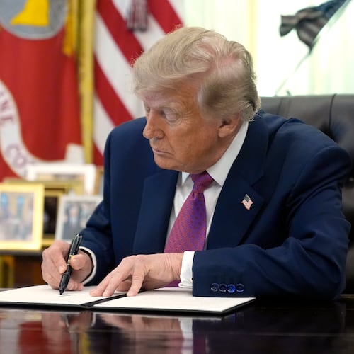 President Donald Trump signs an executive order in the Oval Office of the White House, Thursday, Aug. 27, 2026, in Washington. (AP Photo/Manuel Balce Ceneta)