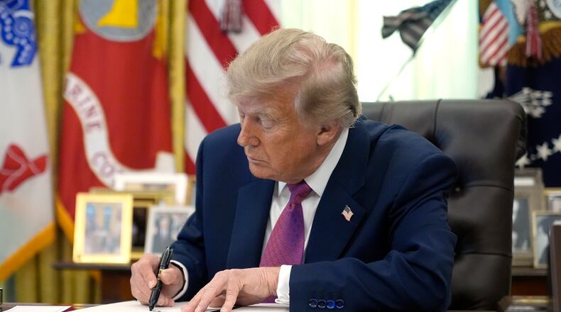 President Donald Trump signs an executive order in the Oval Office of the White House, Thursday, Aug. 27, 2026, in Washington. (AP Photo/Manuel Balce Ceneta)