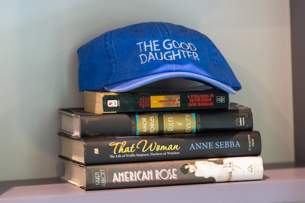 A hat for Karin Slaughter’s book and upcoming TV series "The Good Daughter"rests on some books at her home in Blue Ridge. (Arvin Temkar/AJC)