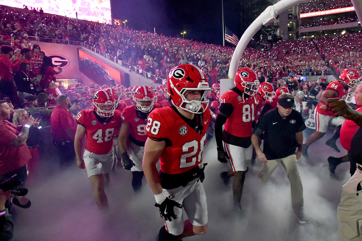 Georgia head coach Kirby Smart and players run onto the field before an NCAA football game against Texas at Sanford Stadium, Saturday, November 15, 2025, in Athens. Georgia won 35-10 over Texas. (Hyosub Shin/AJC)