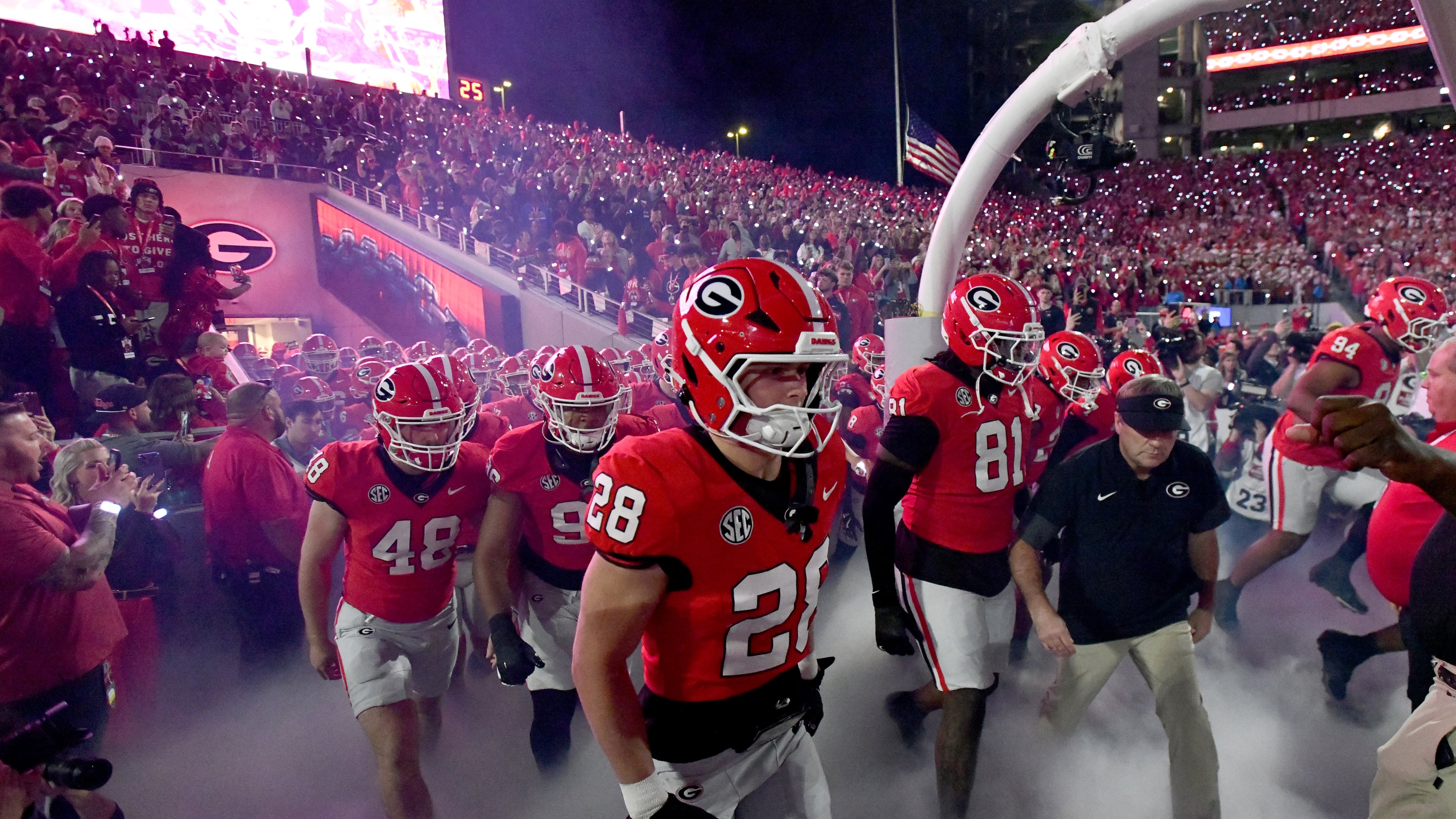 Georgia head coach Kirby Smart and players run onto the field before an NCAA football game against Texas at Sanford Stadium, Saturday, November 15, 2025, in Athens. Georgia won 35-10 over Texas. (Hyosub Shin/AJC)