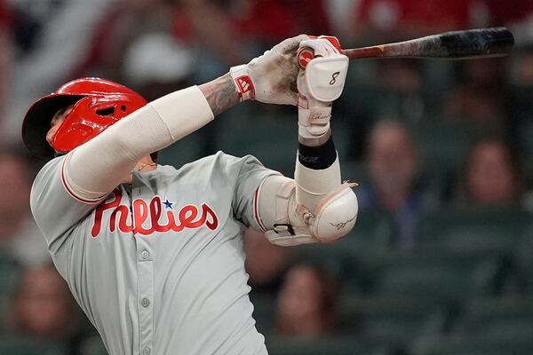 Philadelphia Phillies outfielder Nick Castellanos (8) hits a single in the fourth inning of a baseball game against the Atlanta Braves, Wednesday, April 9, 2025, in Atlanta. (AP Photo/Mike Stewart)