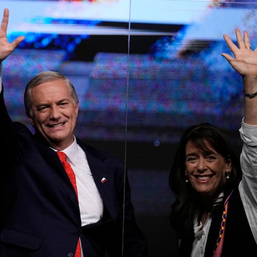 Presidential candidate Jose Antonio Kast of the Republican Party, and his wife Maria Pia Adriasola, wave to supporters after early results in the general elections in Santiago, Chile, Sunday, Nov. 16, 2025. (AP Photo/Esteban Felix)