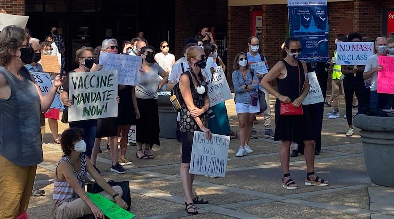 Several dozen people gathered near the University of Georgia's Tate Student Center on Sept. 14, 2021 for a rally aimed at allowing the school and other public universities statewide to mandate wearing masks in indoor spaces and other measures to mitigate the spread of COVID-19. ERIC STIRGUS/ERIC.STIRGUS@AJC.COM.