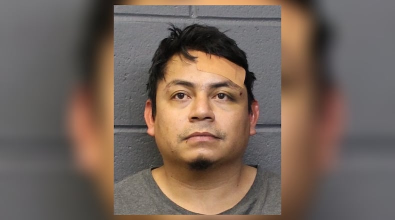 Juan Escalante-Alarcon, 34, of Norcross, was arrested Friday night. He is suspected in a Thursday morning shooting at a Forsyth County home that killed two men and injured a teenager.