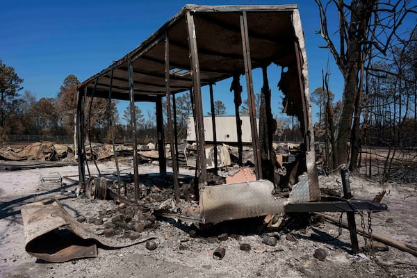 A burned trailer sits near a destroyed home as the Brantley Highway 82 fire burns on Thursday, April 23, 2026, near Nahunta. (Mike Stewart/AP)