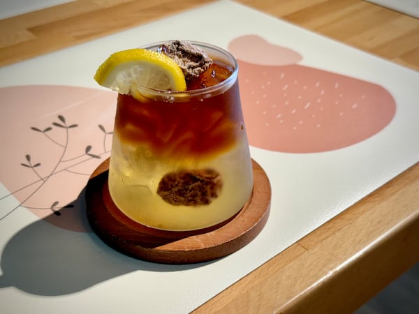 A coffee drink with a layer of coffee over a layer of clear syrup