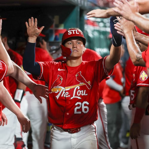 St. Louis Cardinals' JJ Wetherholt is congratulated by teammates after scoring a run during the sixth inning of a baseball game against the Atlanta Braves Friday, July 10, 2026, in St. Louis. (AP Photo/Scott Kane)