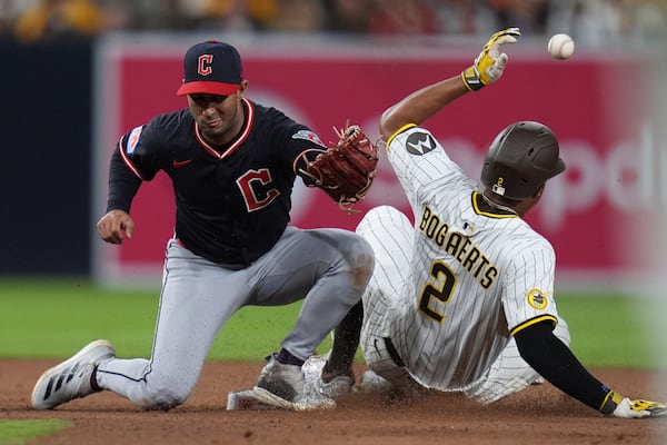 San Diego Padres' Xander Bogaerts (2) steals second base as Cleveland Guardians shortstop Brayan Rocchio can't make the catch during the seventh inning of a baseball game Tuesday, April 1, 2025, in San Diego. Cleveland Guardians catcher Bo Naylor picked up a throwing error on the play. (AP Photo/Gregory Bull)