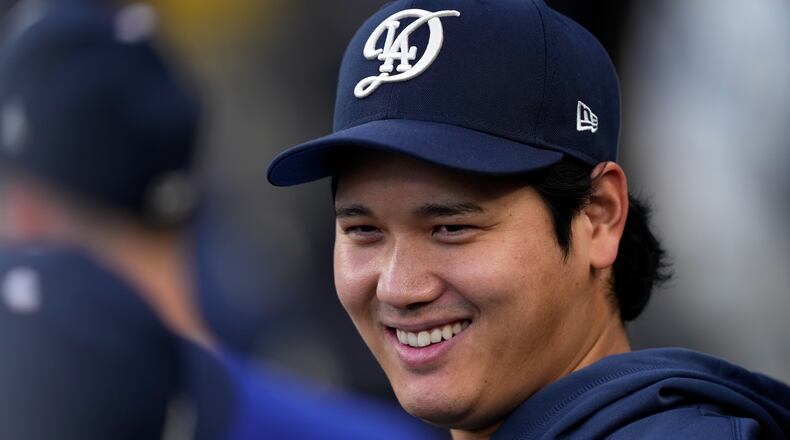 Los Angeles Dodgers' Shohei Ohtani smiles in the dugout during the first inning of a baseball game against the Washington Nationals, Saturday, Sept. 5, 2026, in Los Angeles. (AP Photo/Mark J. Terrill)