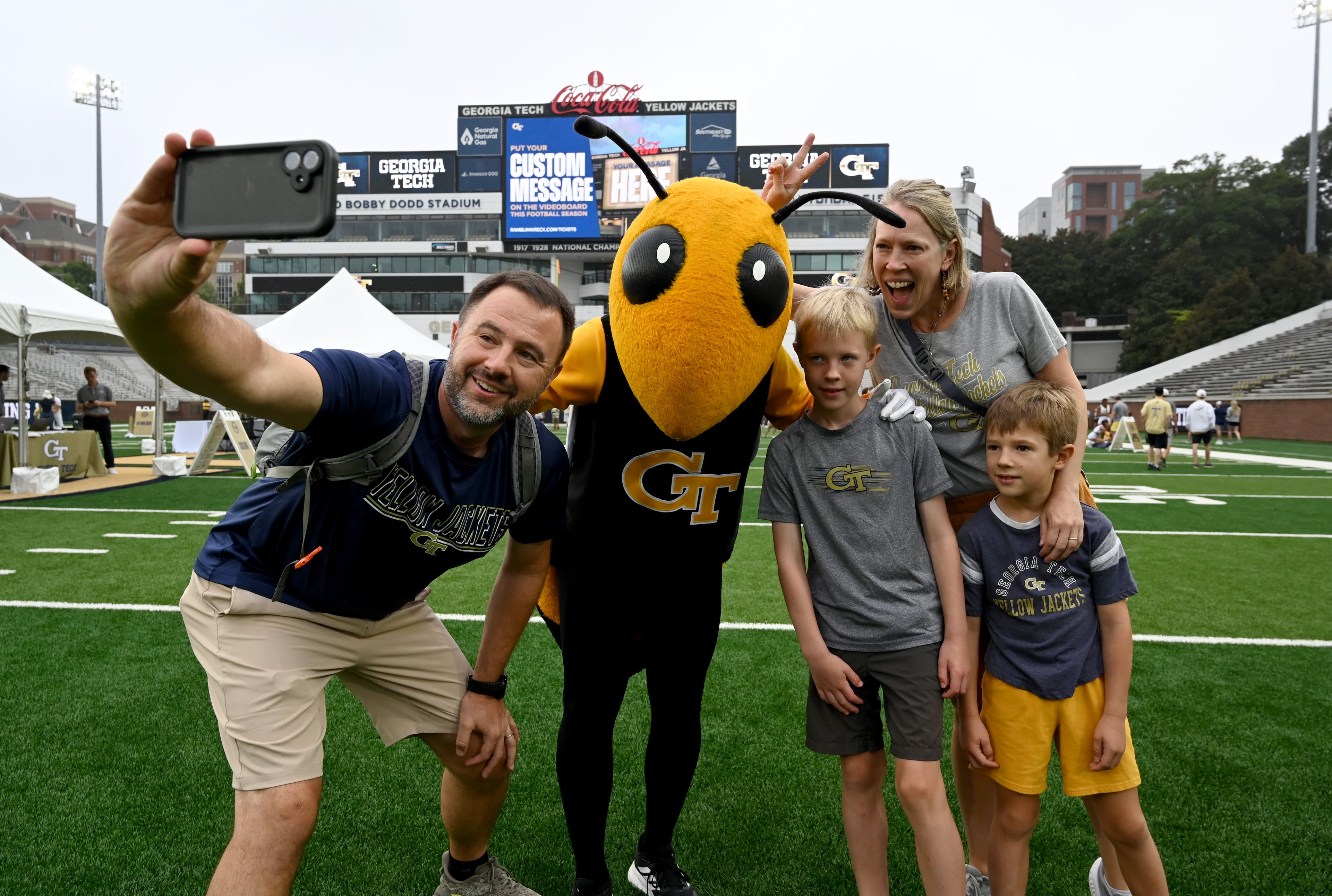 Jay Wozniak (left) and his family got friendly with mascot Buzz at Georgia Tech's recent "First Saturday on the Flats" event.