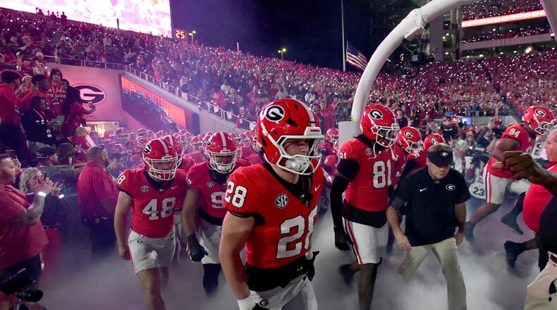 Georgia head coach Kirby Smart and players run onto the field before an NCAA football game against Texas at Sanford Stadium, Saturday, Nov. 15, 2025, in Athens. Georgia won 35-10 over Texas. (Hyosub Shin/AJC)