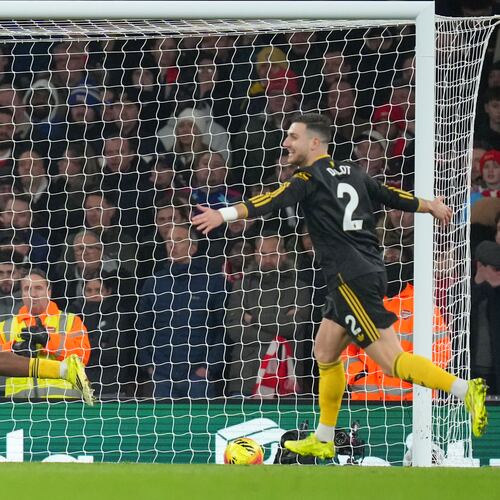 Manchester United's Patrick Dorgu, left, celebrates scoring his side's second goal during the English Premier League soccer match between Arsenal and Manchester United in London, Sunday, Jan. 25, 2026. (AP Photo/Kirsty Wigglesworth)