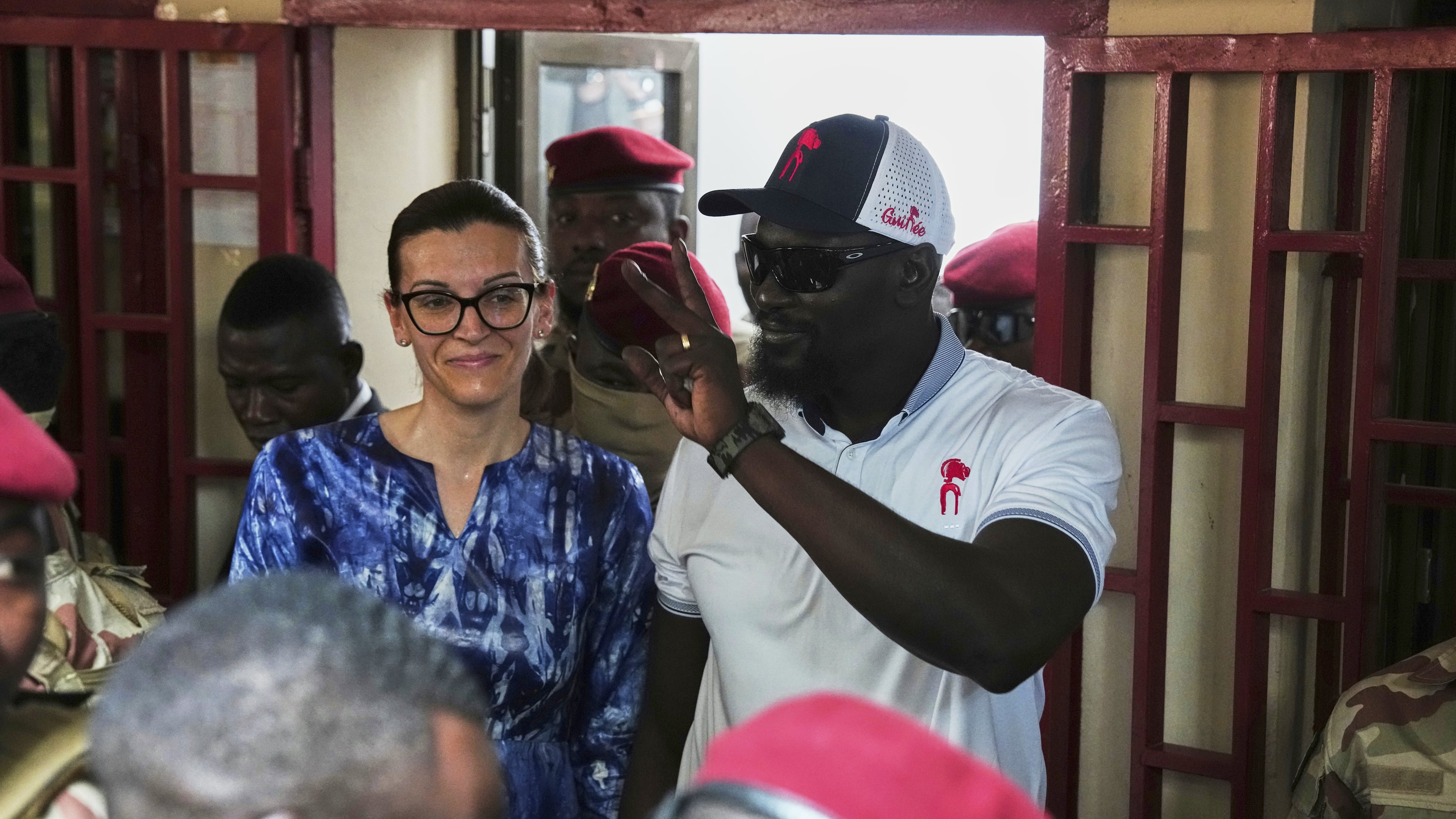 Guinea's interim President, Gen. Mamadi Doumbouya, departs with his wife after casting his vote in the constitutional referendum in Conakry, Guinea, Sunday, Sept. 21, 2025. (AP Photo/Misper Apawu)
