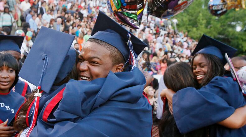 Dunwoody High School graduates celebrate after a ceremony in Chamblee. (BOB ANDRES / BANDRES@AJC.COM)