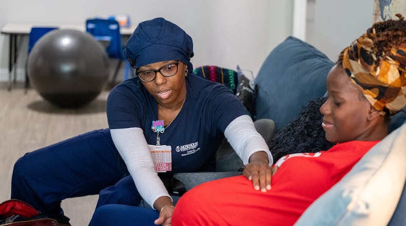 241008 STOCKBRIDGE, GA — (From left) Doula Bashellia Williams checks the baby's position with her client, Reona Porter on Friday, Oct. 8, 2024. Porter was just over 38 weeks pregnant when this photo was taken and her baby arrived two days later.
(Bita Honarvar for The Atlanta Journal-Constitution)