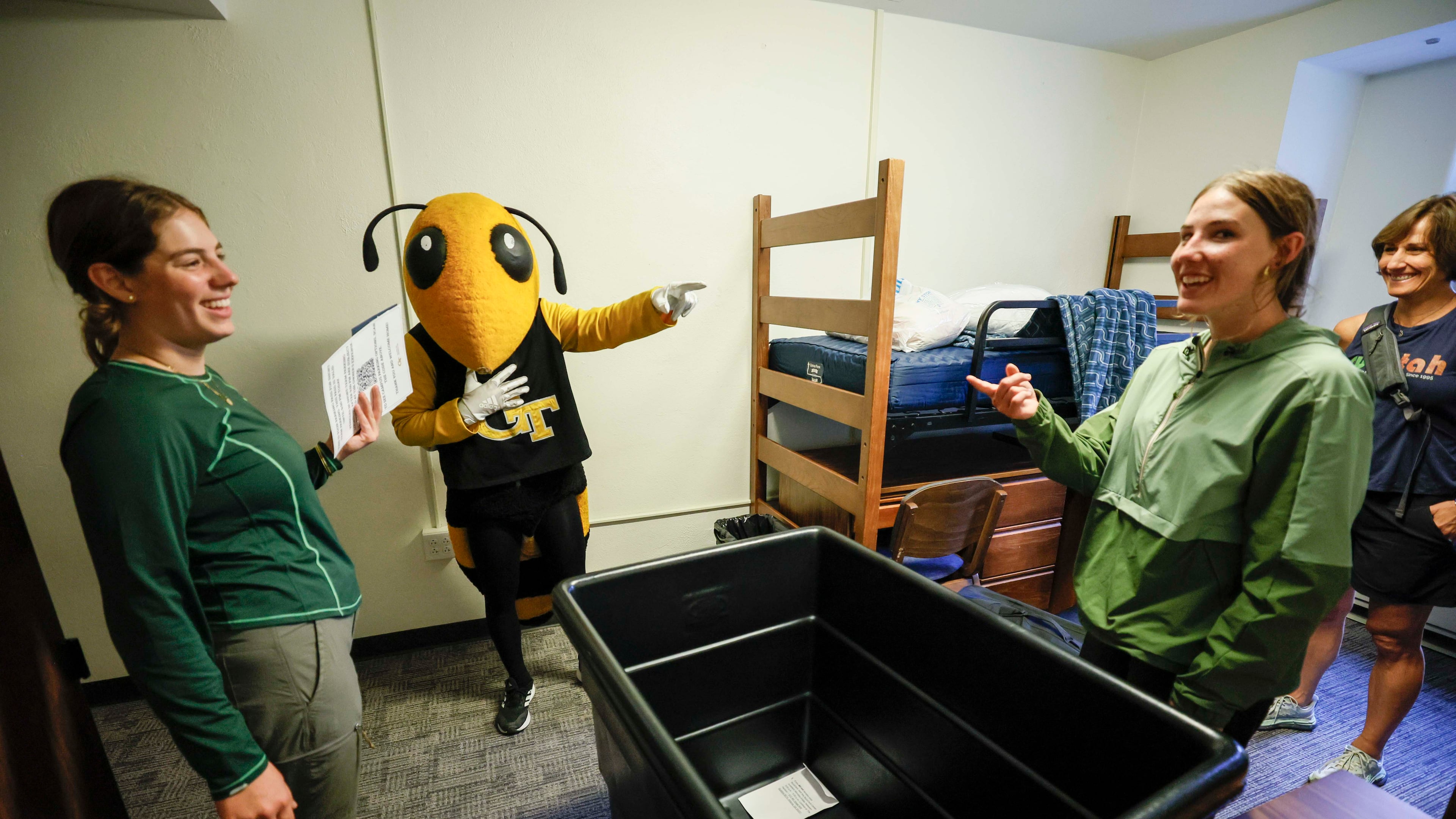 Georgia Tech mascot Yellow Jacket Buzz teases Civil and Environmental student Sofia Jouraron and Mechanical Engineering student Olivia Cozette during move-in day at Georgia Tech on Sunday, Aug. 10, 2025. (Miguel Martinez/AJC)