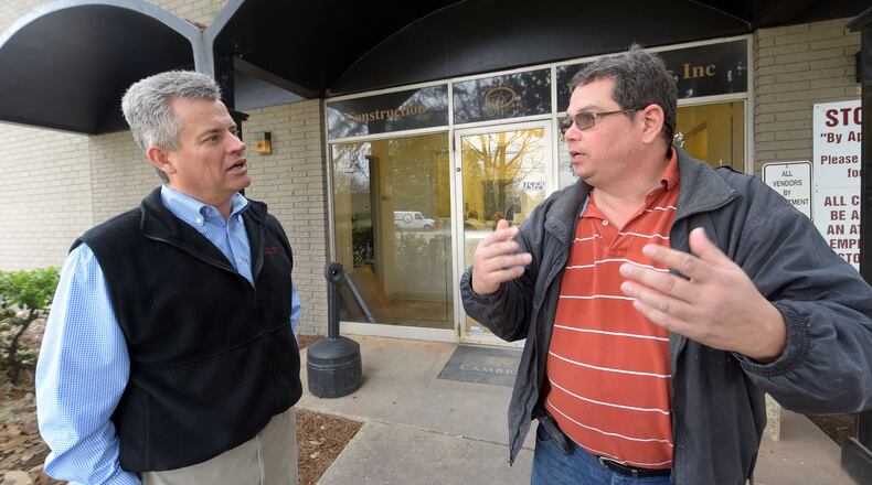 Alejandro Benedetti (right), who operates a computer numerical control (CNC) machine at Construction Resources, talks with CEO Mitch Hires. Benedetti, originally from Colombia, is part of the foreign-born labor force that economists say is key to U.S. economic growth. KENT D. JOHNSON/AJC