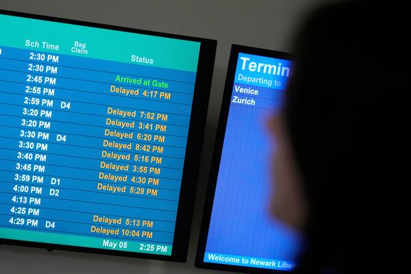 A display shows the status of flights at Newark Liberty International Airport in Newark, N.J., Monday, May 5, 2025. (AP Photo/Seth Wenig)