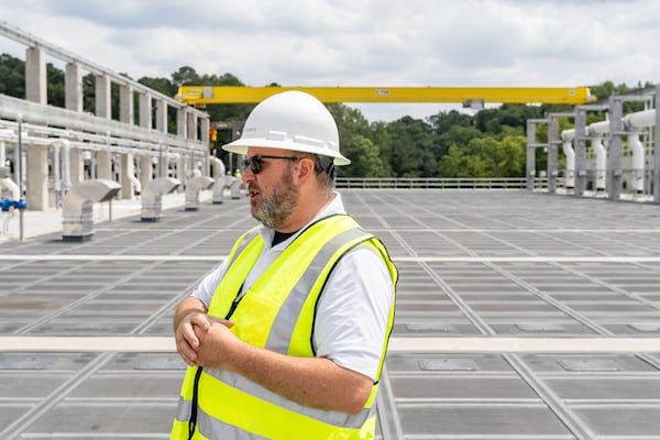 Fulton County Director of Public Works David Clark stands above one of the many new treatment membrane tanks at the new water reclamation facility built on the grounds of the existing Big Creek Wastewater Treament Center.  (Ben Hendren for the AJC 2024)