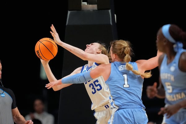 Duke forward Toby Fournier (35) battles for a rebound against North Carolina guard Alyssa Ustby (1)during the second half in the Sweet 16 of the NCAA college basketball tournament, Friday, March 28, 2025, in Birmingham, Ala. (AP Photo/Gerald Herbert)