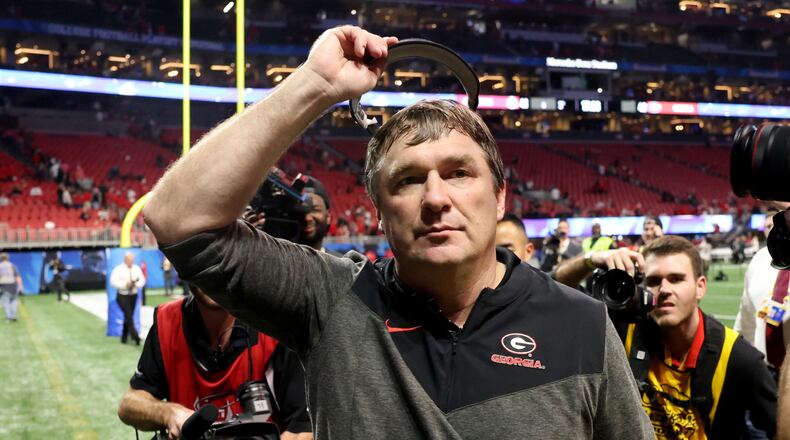 Georgia head coach Kirby Smart celebrates with fans after their 42-41 win against Ohio State in the Peach Bowl Playoff Semifinal, at Mercedes-Benz Stadium, Sat., Dec. 31, 2022, in Atlanta. (Jason Getz / Jason.Getz@ajc.com)