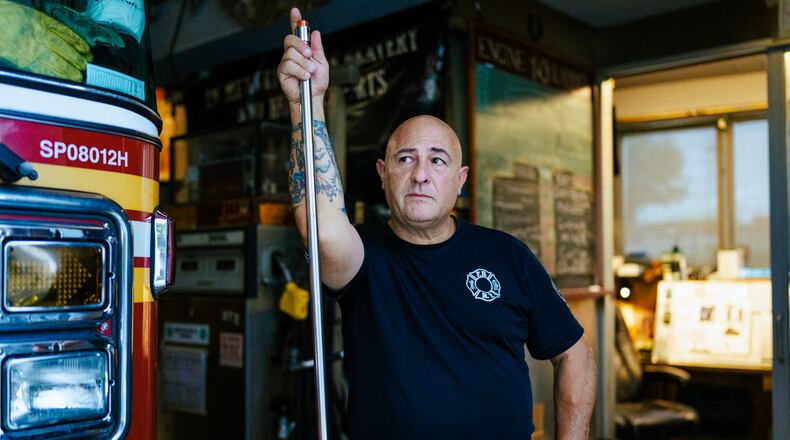 Firefighter Sal Argano, Ladder 10, poses for a portrait at FDNY "Ten House" near Ground Zero on Friday, Aug. 7, 2026, in New York. (AP Photo/Angelina Katsanis)