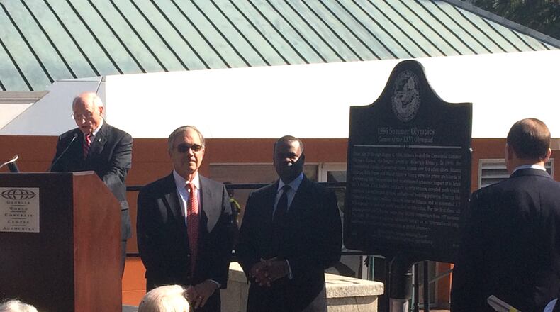 Former Atlanta Committee for the Olympic Games head Billy Payne and Atlantlocated a Mayor Kasim Reed listen to former UGA football coaching legend and Georgia Historical Society board member Vince Dooley at Tuesday mornings dedication of a historical marker to the 1996 Summer Olympics. The marker is near the visitor center in Centennial Olympic Park, the downtown gathering place that was built for the Games held in Atlanta. Photo by Jill Vejnoska