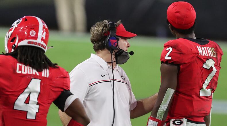 Georgia coach Kirby Smart on the field with D’Wan Mathis and James Cook in the final minutes of the game against the Florida Gators Saturday, Nov. 7, 2020, in Jacksonville, Fla.