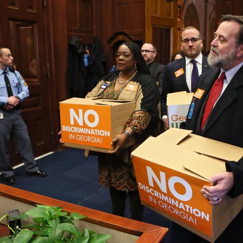 Jeff Graham (right) executive director of Georgia Equality, leads supporters carrying boxes of postcards into then-Gov. Nathan Deal’s office on March 2, 2016. Representatives from gay rights groups delivered copies of 75,000 emails to state leaders urging them to defeat so-called religious liberty legislation they believed would legalize discrimination. (Bob Andres/AJC)