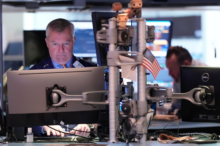 James Lamb works on the floor at the New York Stock Exchange in New York, Thursday, Nov. 13, 2025. (AP Photo/Seth Wenig)