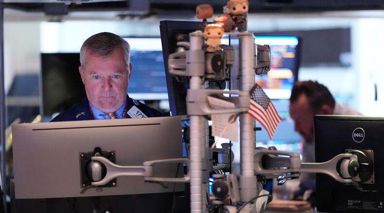 James Lamb works on the floor at the New York Stock Exchange in New York, Thursday, Nov. 13, 2025. (AP Photo/Seth Wenig)